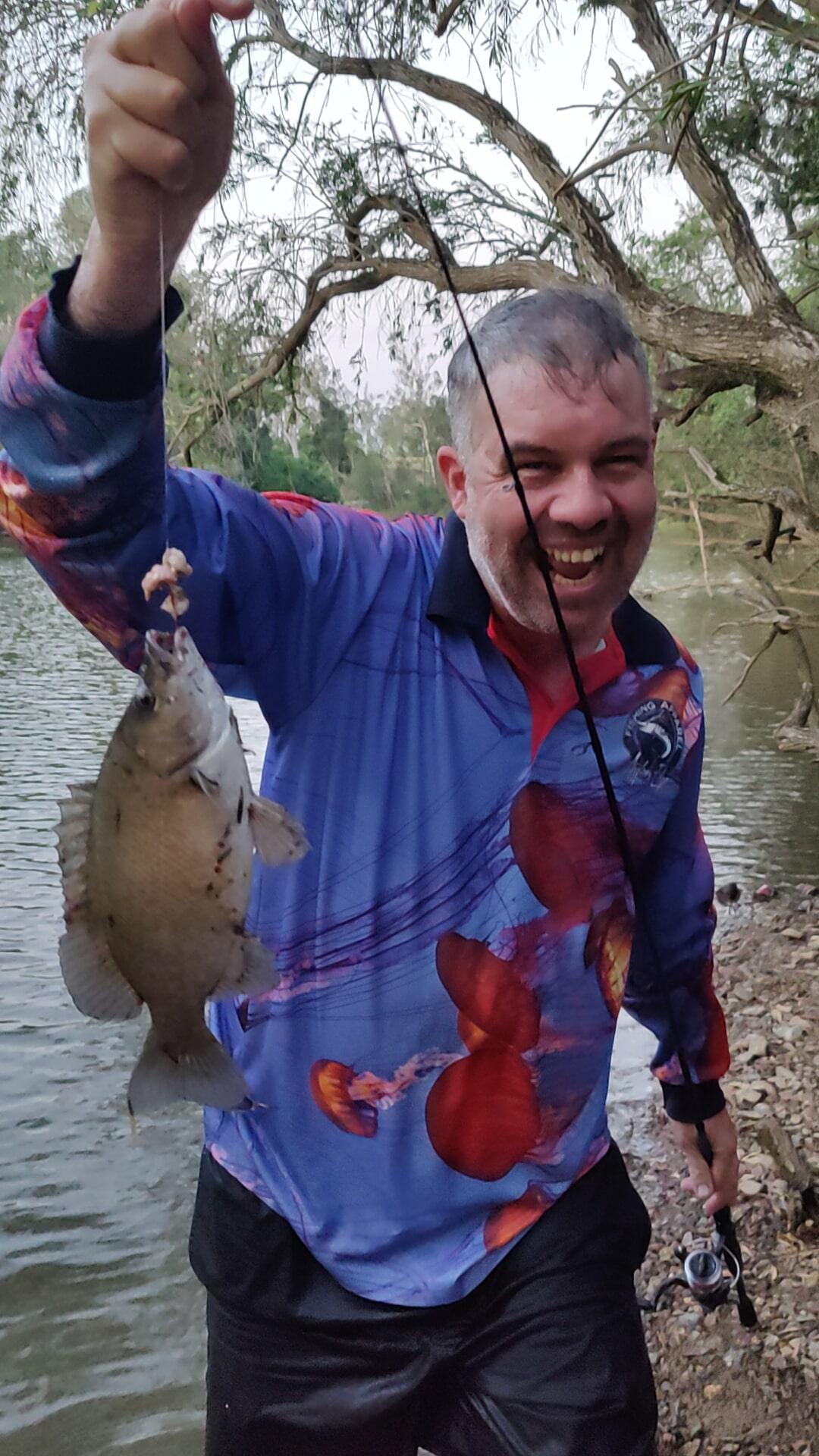 man catching a fish at the Brisbane River