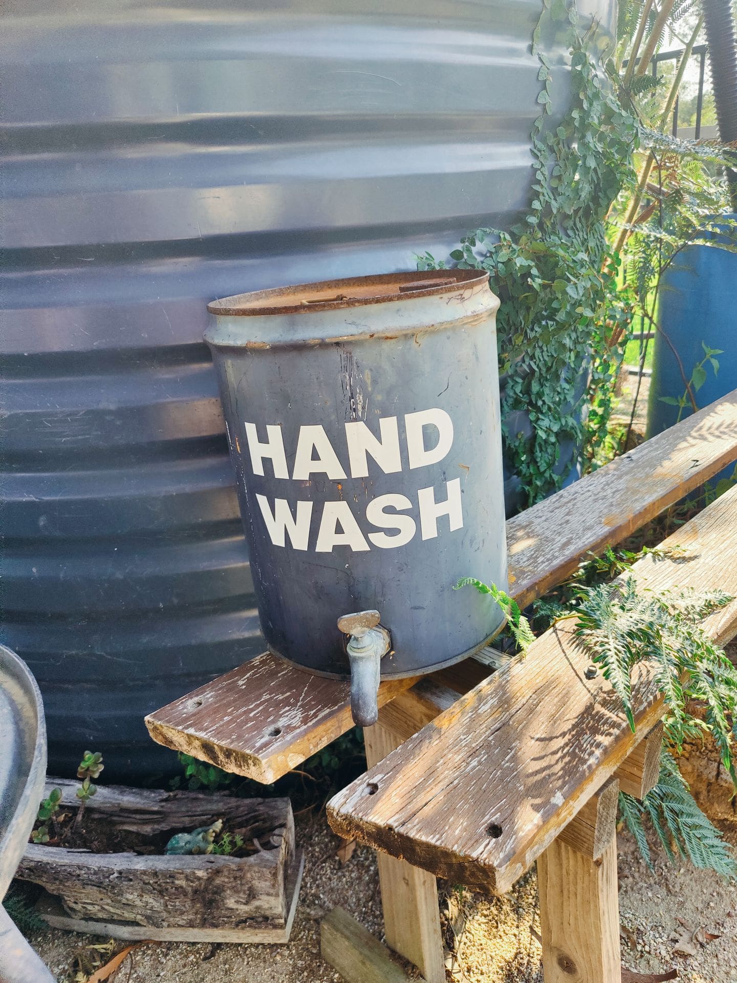 handwash station on top of an old wooden bench