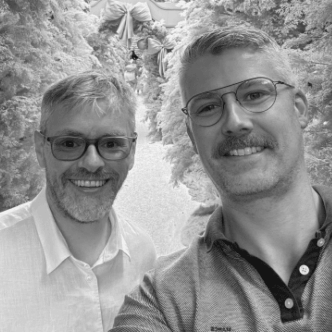 two people taking a photo within some trees