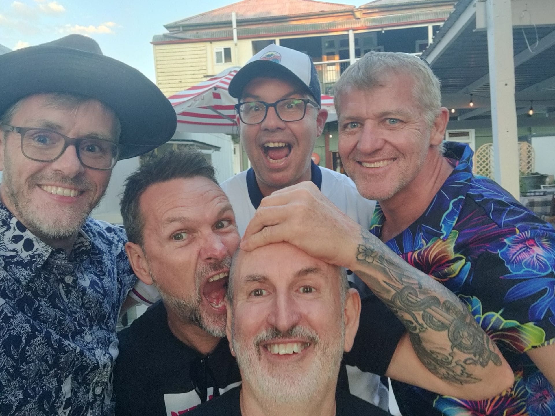 group of friends taking a photo by the beach